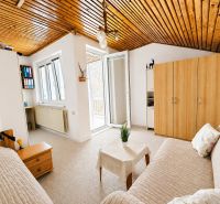 A bright room in a family house with a sofa set and a wardrobe.