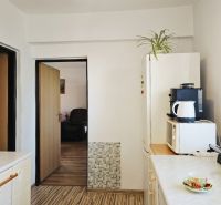 A kitchen in a family house with a wooden decor floor and appliances.
