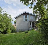 A family house in Nižná Hutka surrounded by greenery and trees.