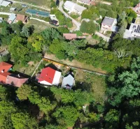 Aerial view of Gardens in Kolačno with scattered houses and lush greenery.
