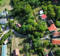 Aerial view of picturesque Gardens in Kolačno with scattered houses and greenery.