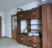 Interior of manufacturing spaces with wood-patterned flooring and wooden furniture.