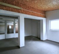 Production premises with white walls and a window, floor with wooden decor.