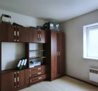Bright office space with furniture and wood-patterned flooring.
