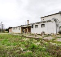 Production premises in Lesenice with an adjacent garden and a simple building facade.