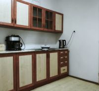 A kitchen in production premises with wooden decor on furniture.
