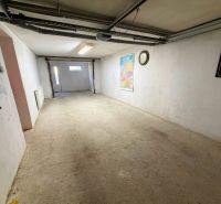 A garage in a family house with a map and a clock on the wall.