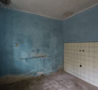 Blue room with a white tiled wall in a family house.