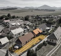 Aerial view of family houses in Žabokreky surrounded by fields and mountains.
