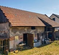A family house in Žabokreky with an unmaintained garden and an outbuilding on the property.