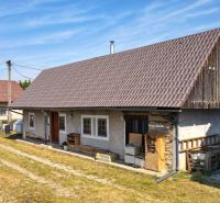 A family house in Žabokreky with a large roof, wooden details, and a yard.