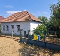 A family house in Dolné Otrokovce with a fence and a garden on a sunny plot.