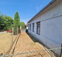 A family house in Dolné Otrokovce with fencing and a driveway in the yard.