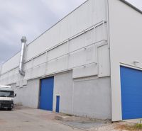 Production facilities on Priemyselná Street in Galanta with a truck in front of the blue gates.