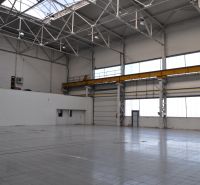 Production facilities with high ceilings, windows, and concrete floors.