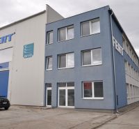Production premises on Priemyselná Street in Galanta with a gray building and a parking lot.