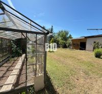 A greenhouse and a garden at a family house in Kláštor pod Znievom on a sunny plot.