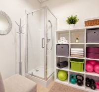 Shower corner, shelves with towels and fitness equipment in commercial premises.