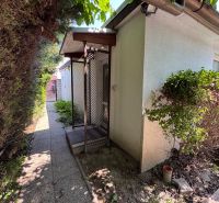 Family house on Senná Street in Bratislava - Ružinov, side garden with a walkway.