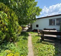 The garden of a family house in Bratislava - Ružinov on Senná Street with wooden seating.