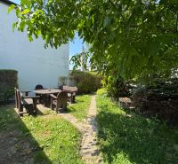 The garden of a family house on Senná Street in Bratislava - Ružinov, with seating in pleasant shade.