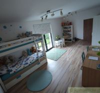 Children's room with a bunk bed, a desk, and a floor with a wooden decor.