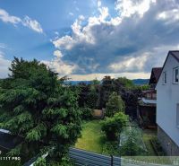 A family house in Banská Bystrica with a large garden, surrounded by greenery and trees.
