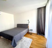 Bedroom in a 4-room apartment with a bed, curtains, and a floor with a wooden decor.