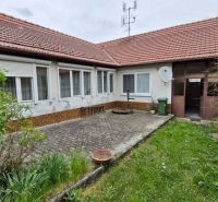 The courtyard of the family house in Mokrý Háj with a paved terrace and garden.