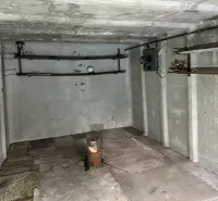 Concrete room with wall mounts and a floor with wood decor in garages.
