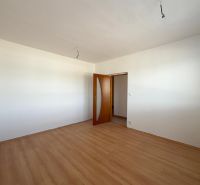 A room in a 2-room apartment with a floor featuring a wood decor and white walls.