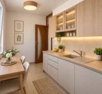 A kitchen in a 2-room apartment with wooden decor and decorative plants on the table.