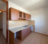 A kitchen in a 2-room apartment with a kitchen unit and tiled floor.