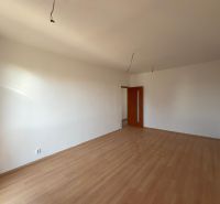 A room with walls in a 2-room apartment and a floor with a wooden decor.