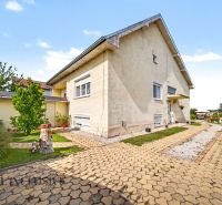 A family house on Vojtechovce Street in Nový Život is surrounded by a well-maintained garden with a walkway.