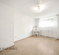 A room with a wooden decor floor and a dressing table in a family house.