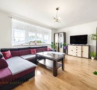 Living room in a family house with a corner sofa and a wooden decor floor.