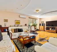Bright living room in a family house with comfortable seating and a wooden decor floor.