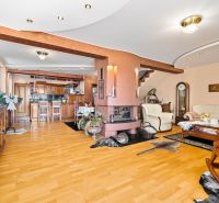 Living room in a family house with a fireplace and a wooden decor floor.