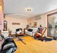 Living room in a family house with a fireplace and a floor with a wood decor.