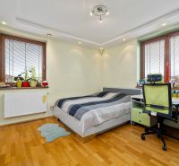 A children's room in a family house with a bed, a desk, and a floor with a wooden decor.