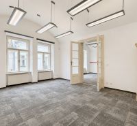 Offices with a tiled stove and pendant lights, floor with wooden decor.