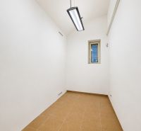 White walls, small room, ceiling lights, tiles, offices.