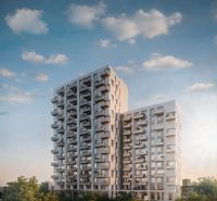 A high-rise building on Mlynské Nivy in Bratislava - Ružinov with balconies and greenery.