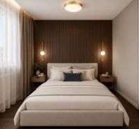 Bedroom with an upholstered bed, wooden paneling, and two nightstands in a three-room apartment.