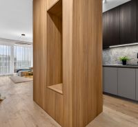 Interior of a 2-room apartment with a wooden decor floor, with minimal furnishings.