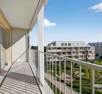 The balcony of a 2-room apartment on Bajkalská Street with a view of greenery in Bratislava.