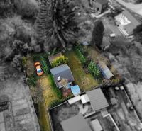 Aerial view of a cottage with a garden and a car in Žilina.