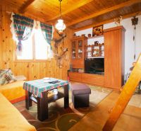 Interior of a cabin with wooden decor and traditional furnishings for a cozy stay.