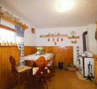 Interior of a cabin with rustic furniture and decorations, floor with wooden decor.